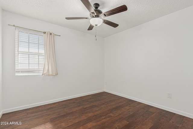 unfurnished room with ceiling fan, dark wood-type flooring, and a textured ceiling