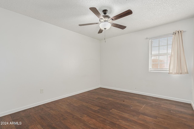 empty room with ceiling fan, dark hardwood / wood-style floors, and a textured ceiling