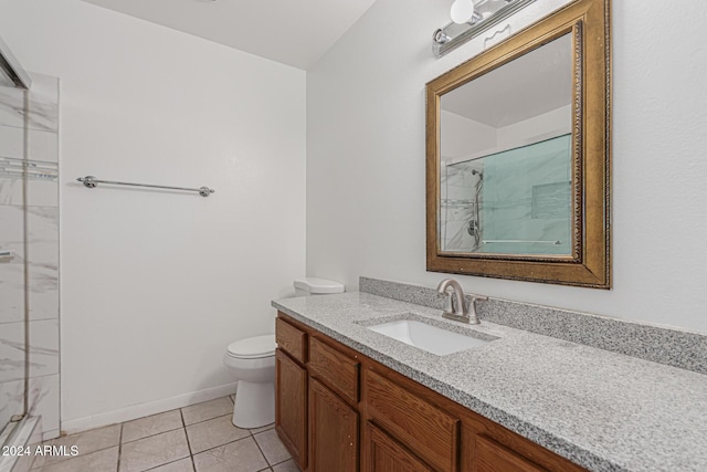 bathroom with vanity, tile patterned floors, a shower with door, and toilet