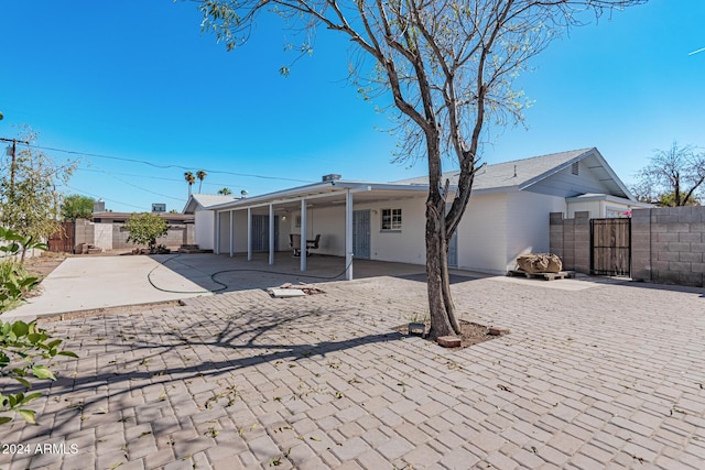 back of property with a patio