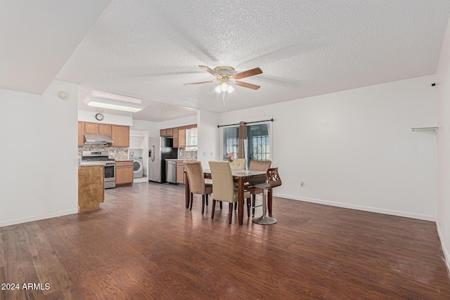 dining area featuring ceiling fan, dark hardwood / wood-style floors, washer / dryer, and a textured ceiling