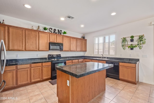 kitchen with a center island, black appliances, sink, dark stone countertops, and light tile patterned floors