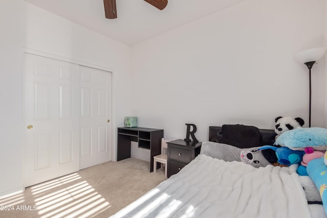 carpeted bedroom with ceiling fan and a closet