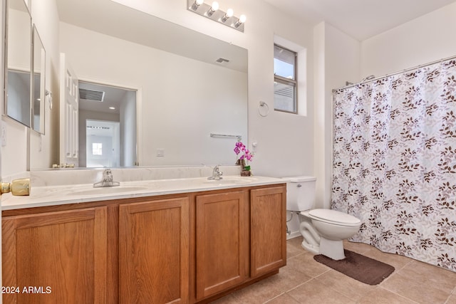 bathroom featuring tile patterned floors, vanity, curtained shower, and toilet