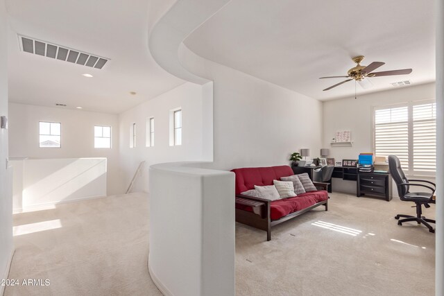 carpeted office space with a wealth of natural light and ceiling fan