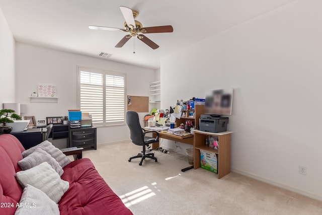 carpeted office featuring ceiling fan