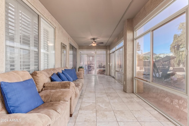 sunroom / solarium featuring ceiling fan