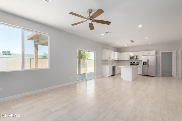 10785 W Arivaca Dr, Arizona City, AZ 85123 - unfurnished living room with visible vents, baseboards, a sink, a ceiling fan, and recessed lighting