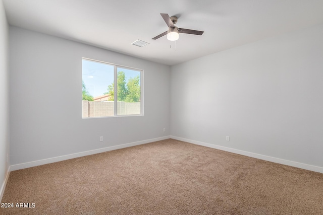 10785 W Arivaca Dr, Arizona City, AZ 85123 - carpeted spare room with visible vents, baseboards, and a ceiling fan