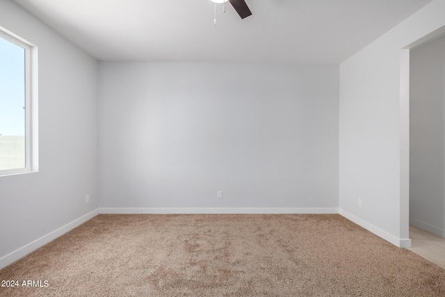 10785 W Arivaca Dr, Arizona City, AZ 85123 - unfurnished room with light colored carpet, ceiling fan, and baseboards
