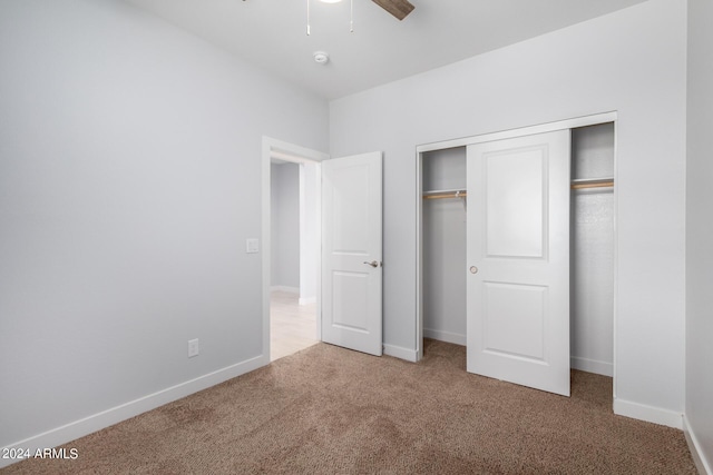 10785 W Arivaca Dr, Arizona City, AZ 85123 - unfurnished bedroom featuring a closet, baseboards, a ceiling fan, and carpet floors