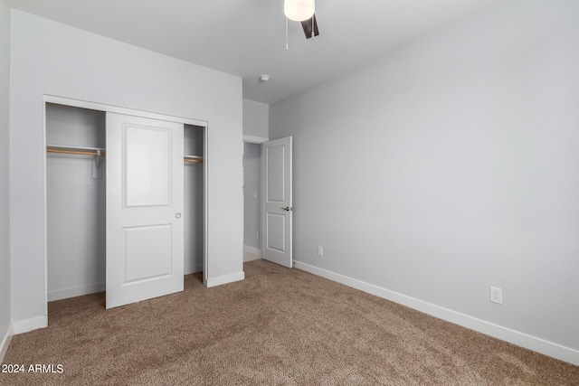10785 W Arivaca Dr, Arizona City, AZ 85123 - unfurnished bedroom featuring a closet, baseboards, a ceiling fan, and carpet