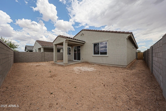 2586 E Music Mountain Ave, Apache Junction, AZ 85119 - back of house with a patio, a tile roof, a fenced backyard, and stucco siding
