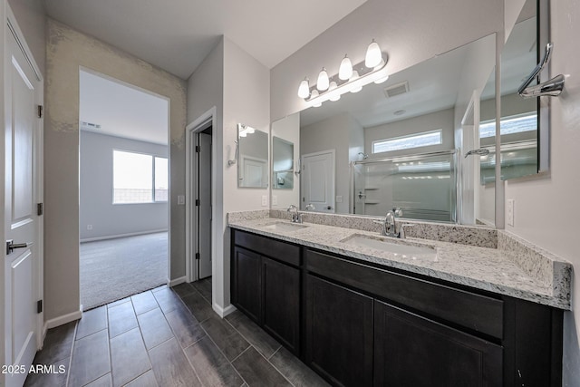 2586 E Music Mountain Ave, Apache Junction, AZ 85119 - full bath with double vanity, an enclosed shower, healthy amount of natural light, and baseboards