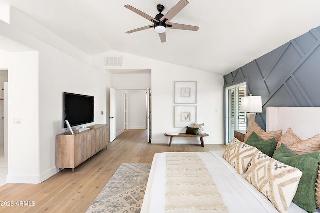 bedroom with ceiling fan, lofted ceiling, and light hardwood / wood-style floors