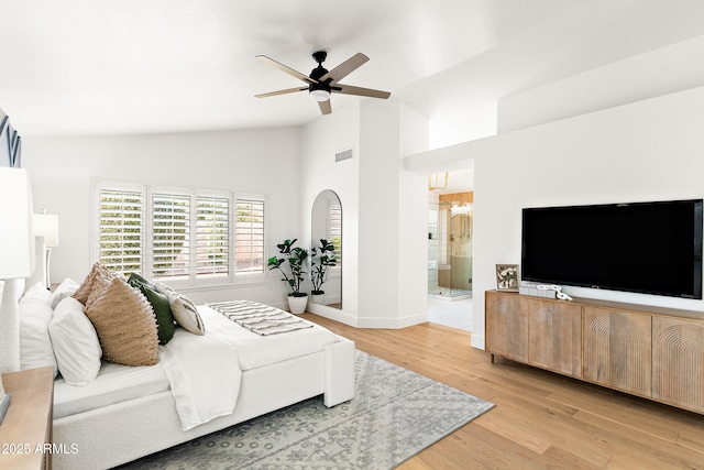 living room with light hardwood / wood-style flooring, high vaulted ceiling, and ceiling fan