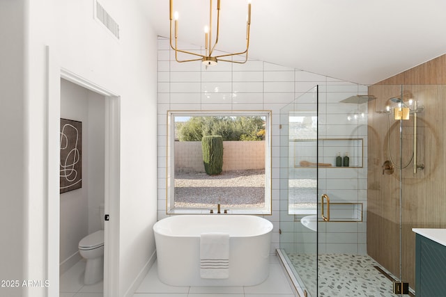 bathroom featuring tile patterned flooring, vaulted ceiling, shower with separate bathtub, and toilet