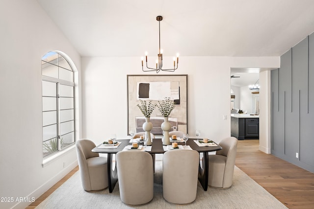 dining room featuring light wood-type flooring and a notable chandelier