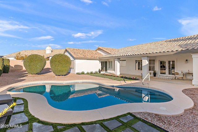 view of pool with a patio and french doors