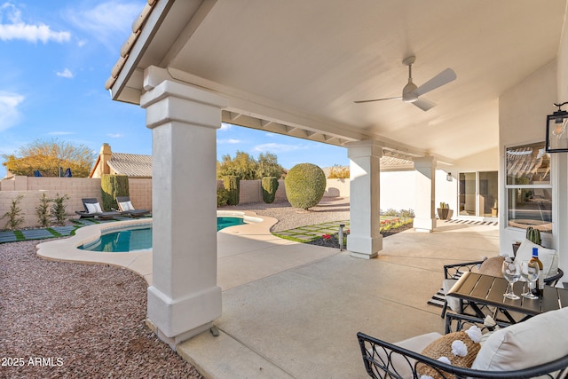 view of patio featuring a fenced in pool and ceiling fan