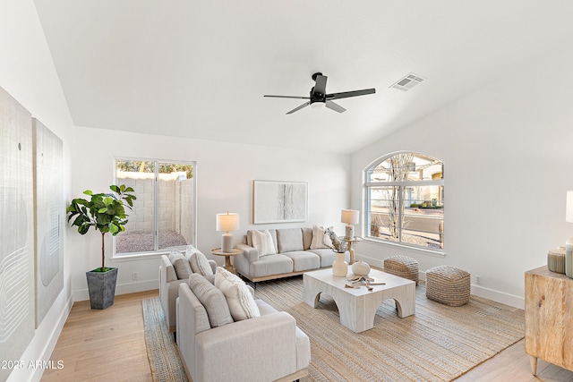 living room with vaulted ceiling, ceiling fan, and light hardwood / wood-style floors