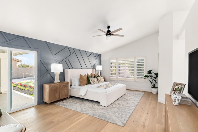 bedroom with hardwood / wood-style flooring, lofted ceiling, access to outside, and ceiling fan