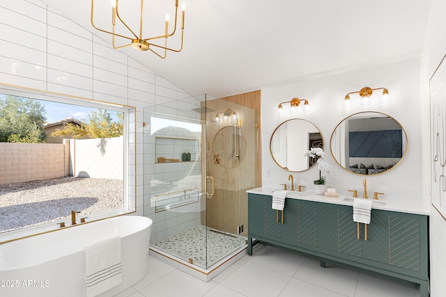 bathroom with tile patterned floors, lofted ceiling, an inviting chandelier, shower with separate bathtub, and vanity