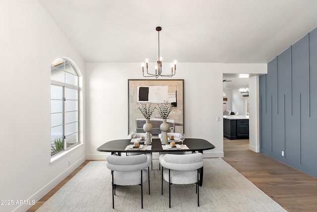 dining area featuring a notable chandelier and light wood-type flooring