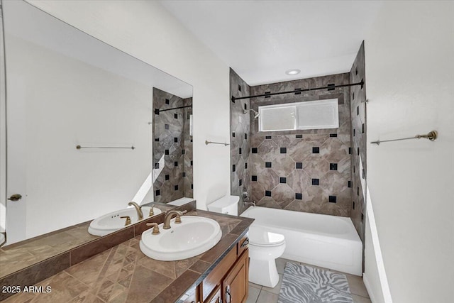 full bathroom featuring vanity, tiled shower / bath, tile patterned floors, and toilet