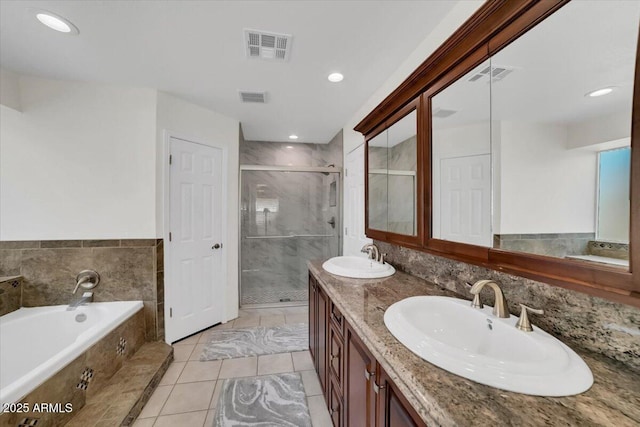 bathroom featuring vanity, shower with separate bathtub, and tile patterned flooring