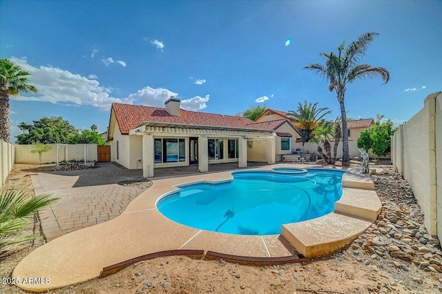 view of pool with an in ground hot tub and a patio