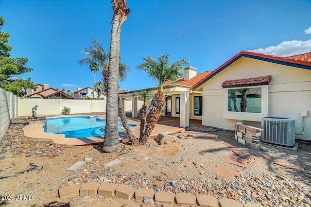 view of swimming pool with central AC unit and a patio