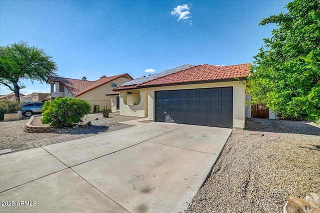 view of front of home with a garage and solar panels