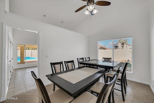 tiled dining area with lofted ceiling, a healthy amount of sunlight, and ceiling fan