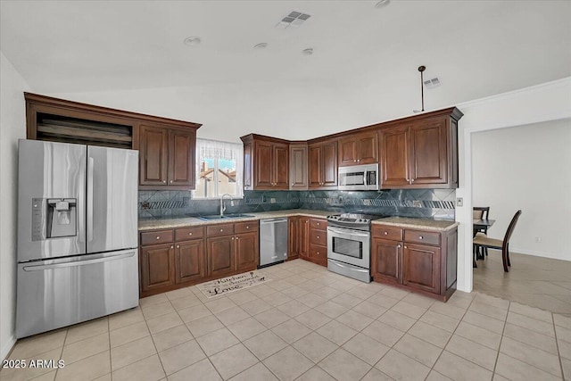 kitchen featuring sink, appliances with stainless steel finishes, tasteful backsplash, light tile patterned flooring, and vaulted ceiling