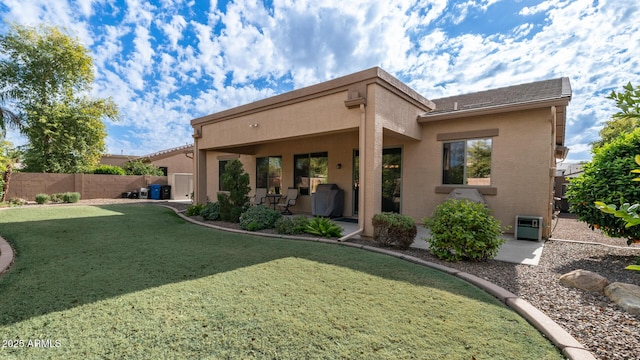 rear view of house with a lawn