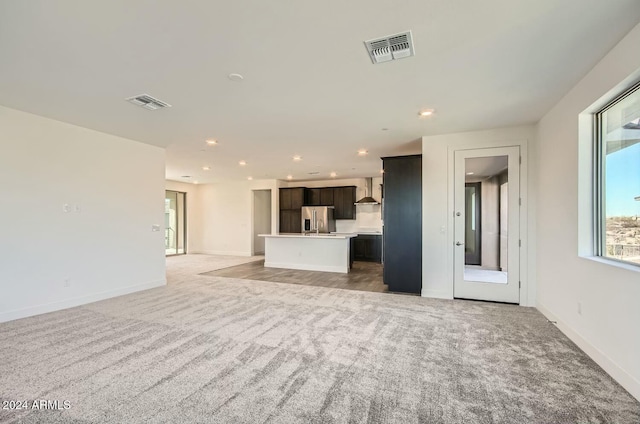 unfurnished living room featuring carpet