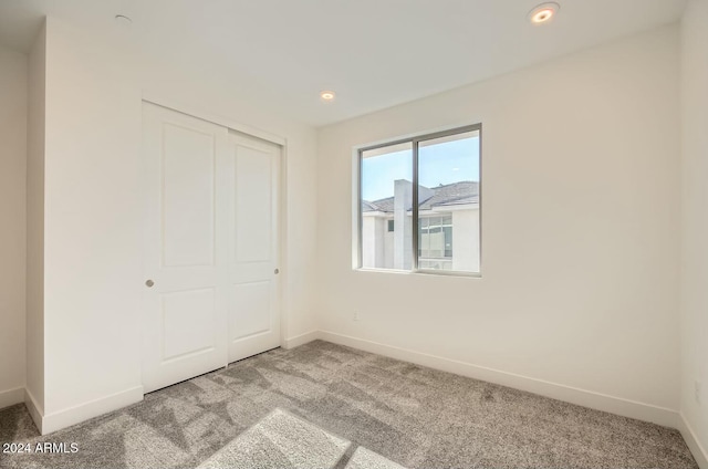 unfurnished bedroom with carpet floors and a closet