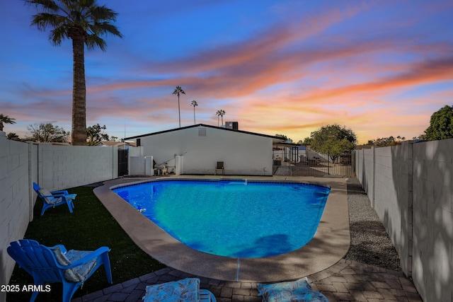 view of pool at dusk