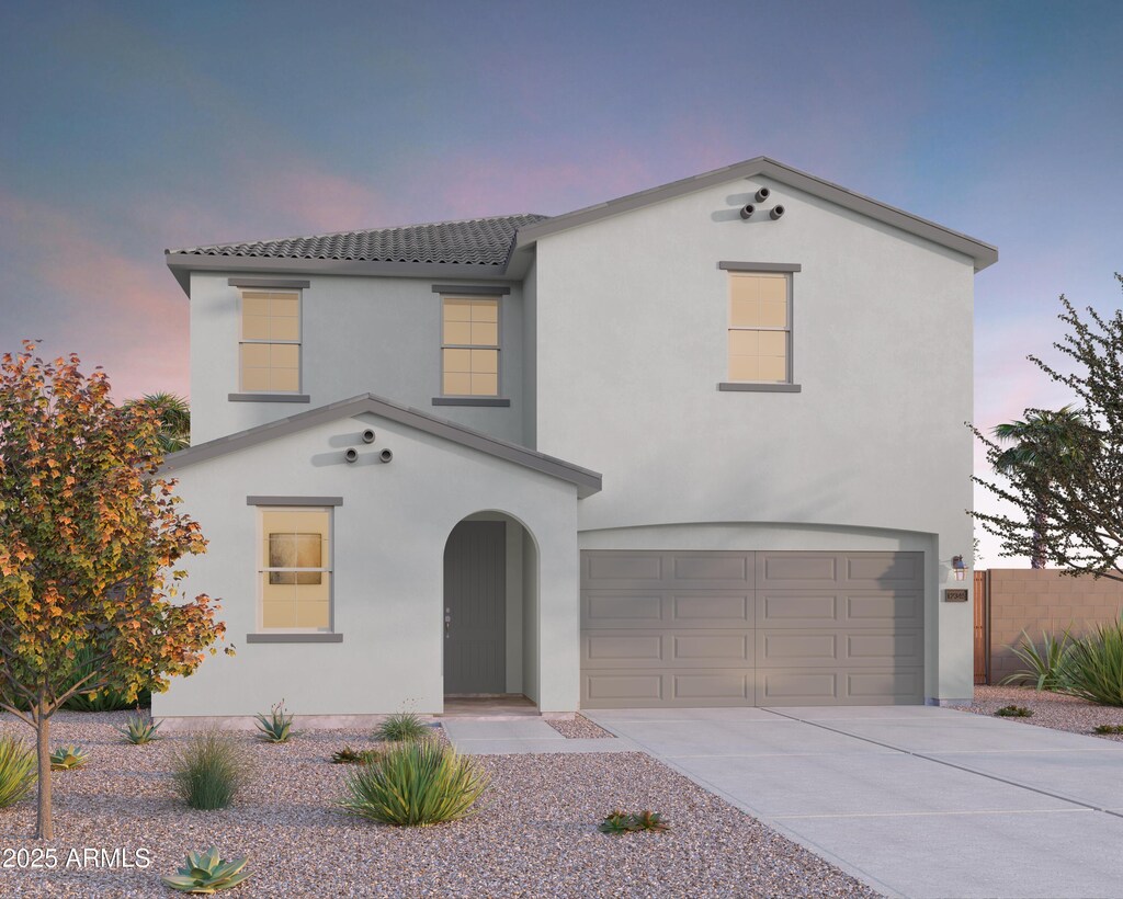 view of front of house featuring stucco siding, concrete driveway, an attached garage, and a tile roof