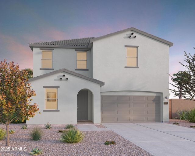 view of front of house featuring stucco siding, concrete driveway, an attached garage, and a tile roof