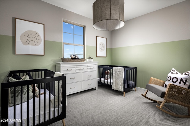 bedroom featuring a nursery area and carpet