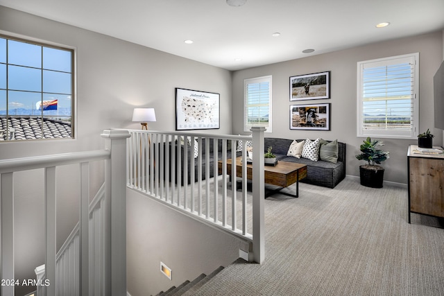 carpeted living room with recessed lighting and a wainscoted wall