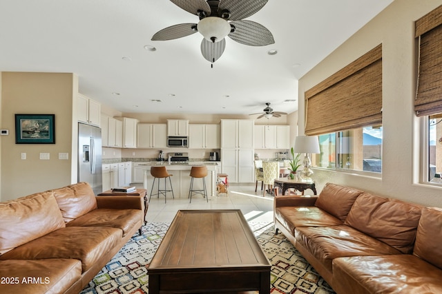 tiled living room with ceiling fan