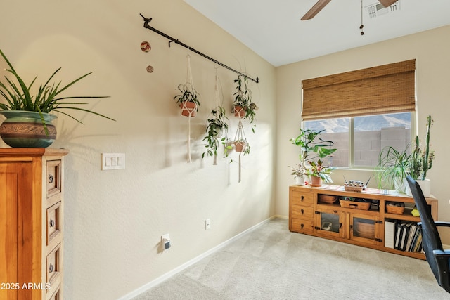 interior space with ceiling fan and light colored carpet