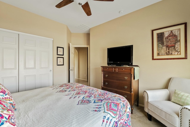 carpeted bedroom with ceiling fan and a closet