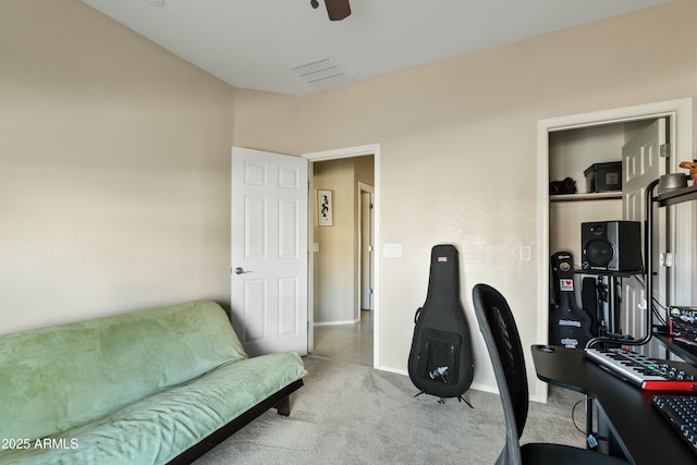 home office featuring light colored carpet and ceiling fan