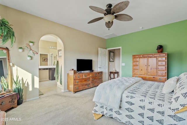 carpeted bedroom featuring connected bathroom and ceiling fan