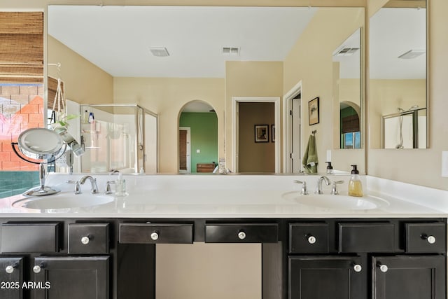 bathroom with an enclosed shower and vanity