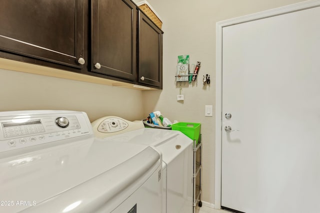 laundry room with cabinets and washer and clothes dryer